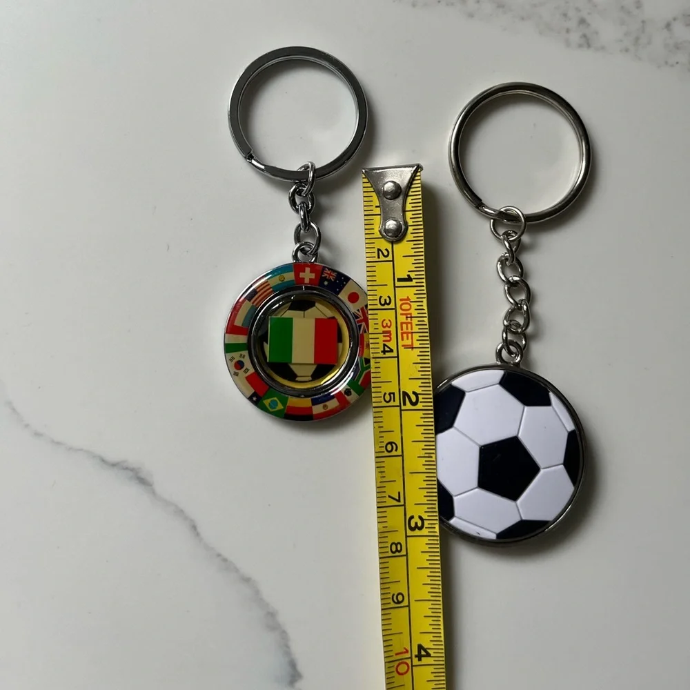 NWOT two soccer keychains. The Italian keychain flips between flag & soccer ball